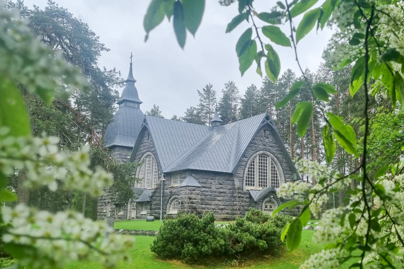Varpaisjärven kirkko, etualalla kukkivia tuomen oksia.